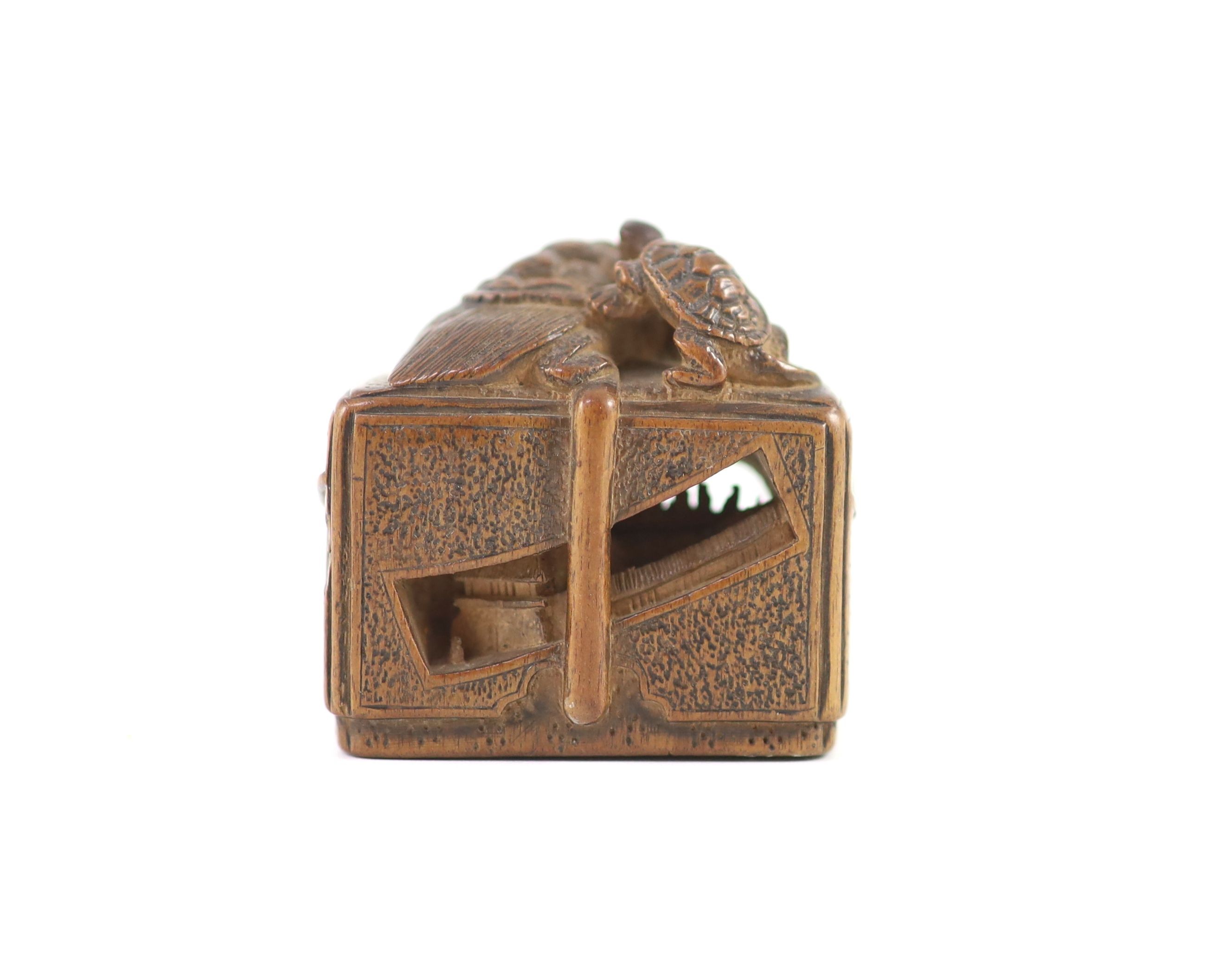 A Japanese boxwood netsuke of a minogame and young perched on the top of a fubako, signed Gyokoku, 19th century, 3.5cm wide